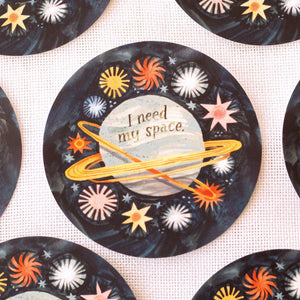 Decorative vinyl sticker with space-themed design and 'I need my space' text on a white background.