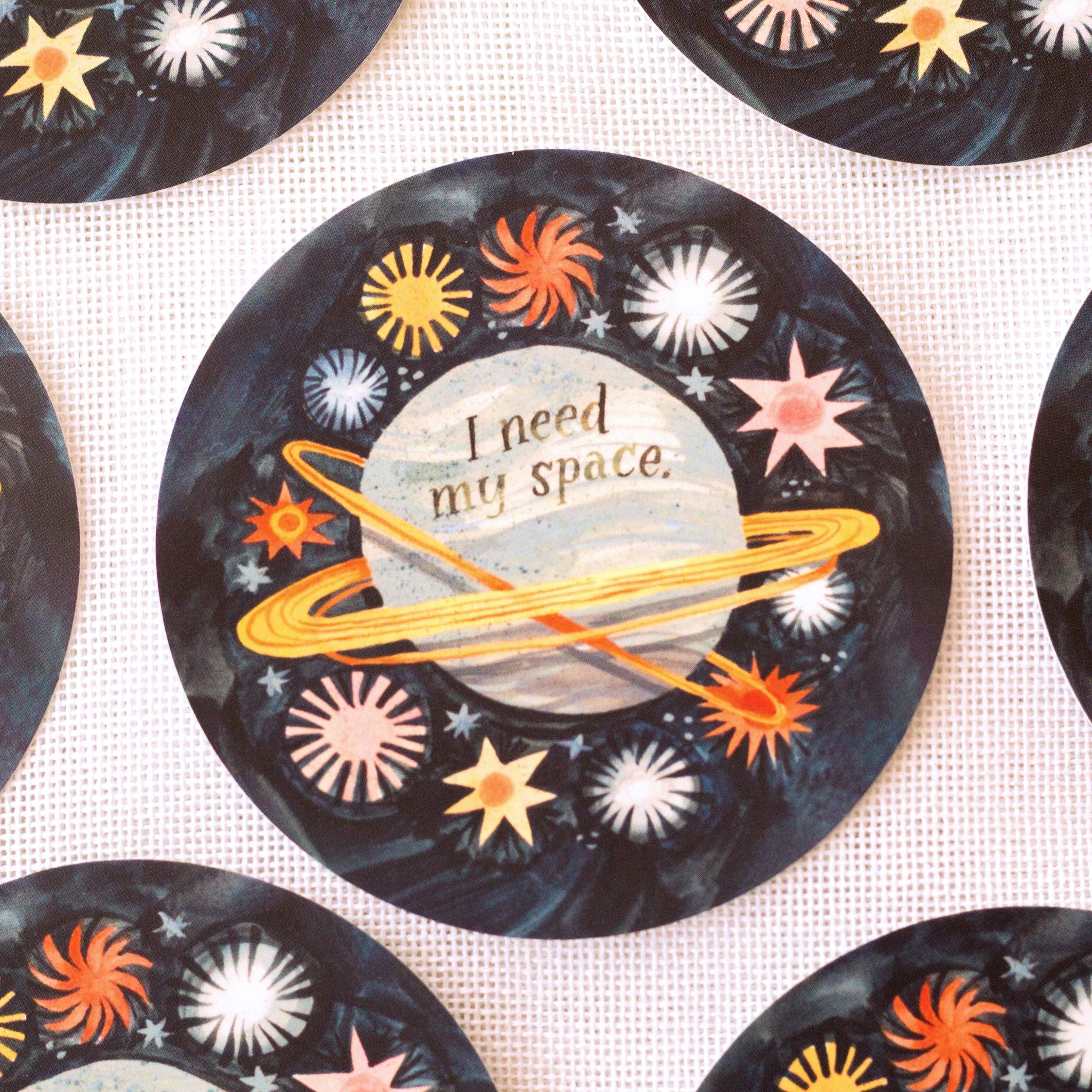 Decorative vinyl sticker with space-themed design and 'I need my space' text on a white background.