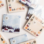 Collection of small sticky notes with various designs on a white surface