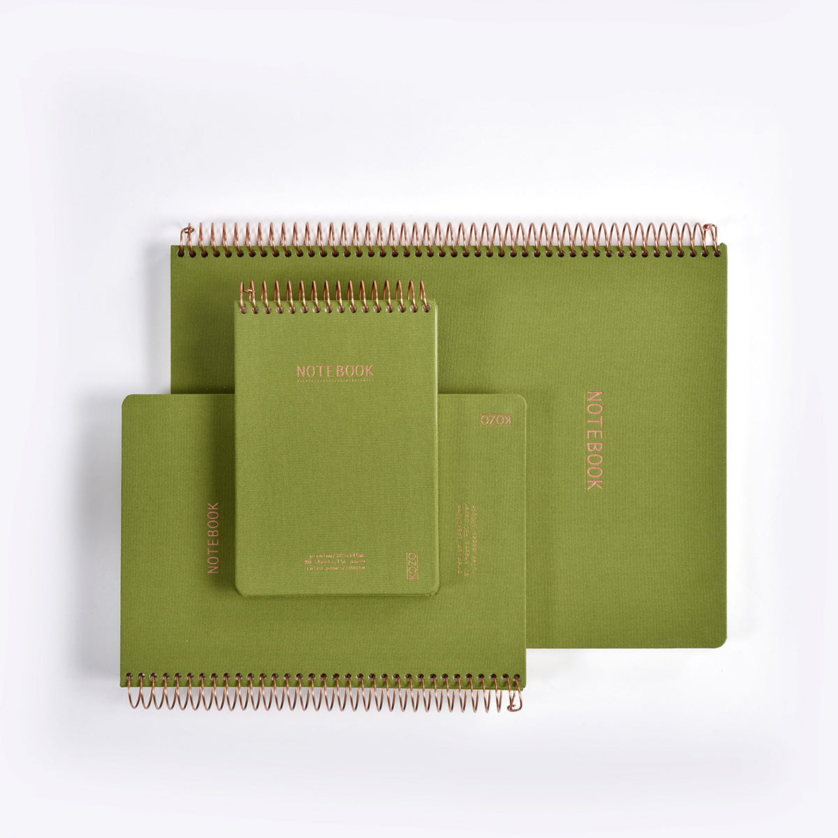 Set of green spiral-bound notebooks on a white background