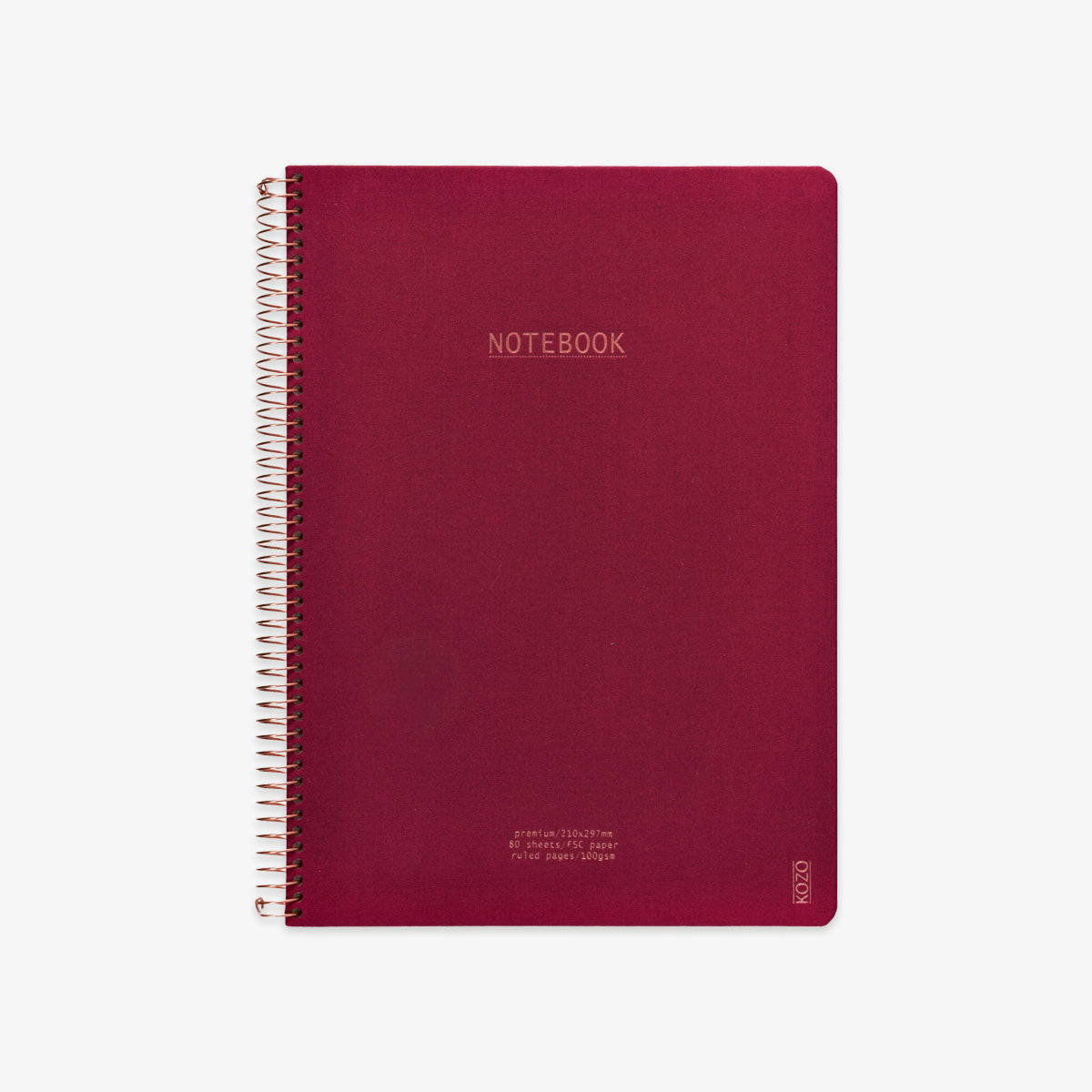 Red notebook with spiral binding on a white background