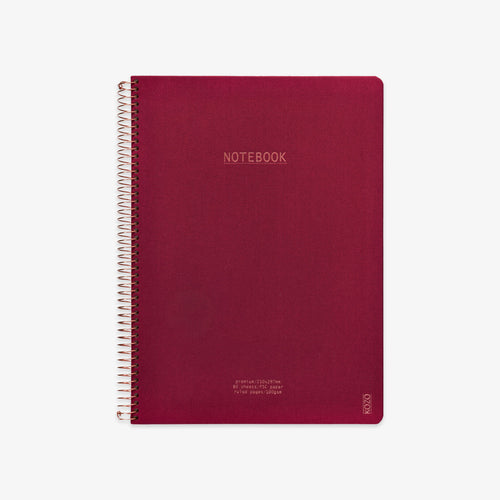 Red notebook with spiral binding on a white background