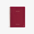 Red notebook with spiral binding on a white background