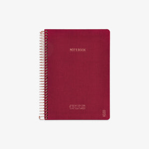 Red notebook with spiral binding on a white background