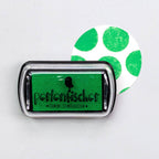 Green ink pad with 'Perlenfischer' branding on a white background