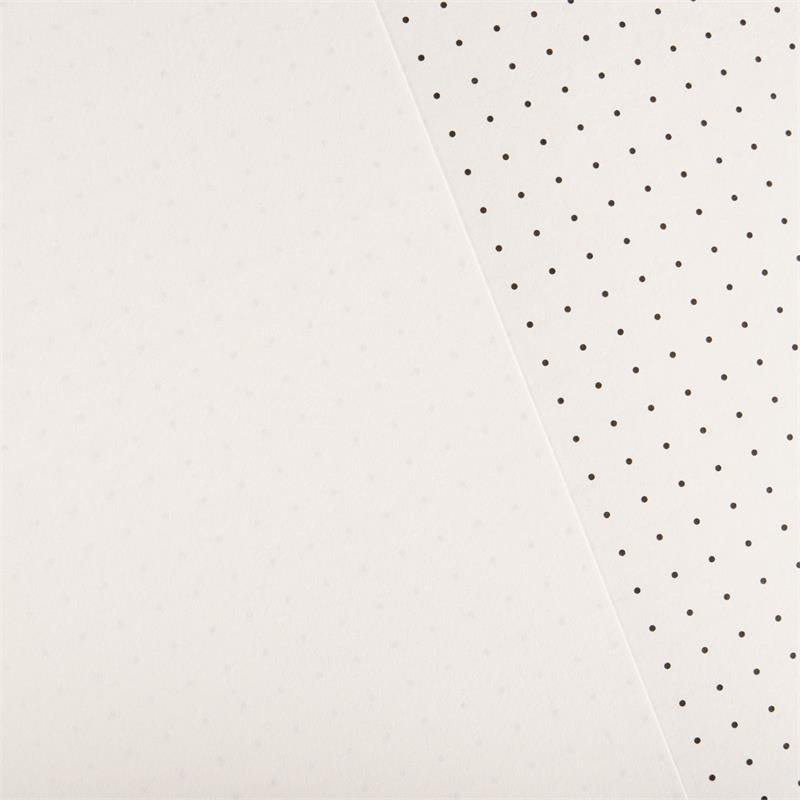 A close-up of a white textured surface split diagonally, with the right side showing a repeating pattern of small black dots.