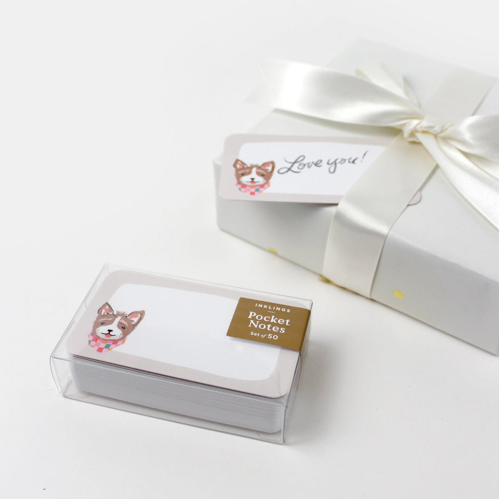 Pocket notes with dog illustration in a clear box on a white background