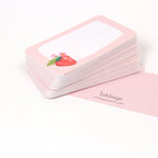Stack of pink cards with a strawberry illustration on a white background, featuring the brand 'inklings'.