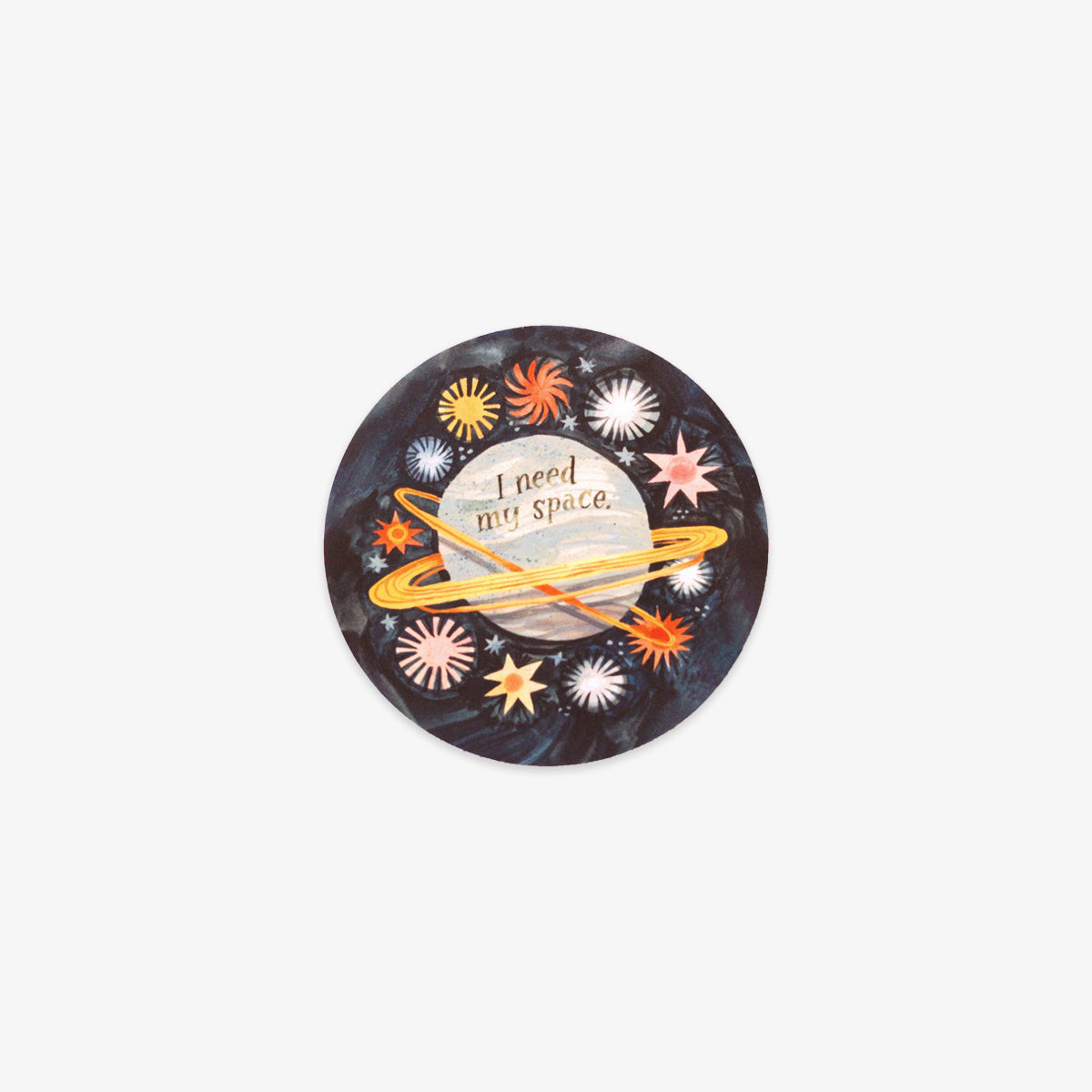 A circular sticker featuring a dark space-themed background with the text 'I need my space' on a planet, surrounded by colorful stars and a yellow ring, shown on a light gray background.