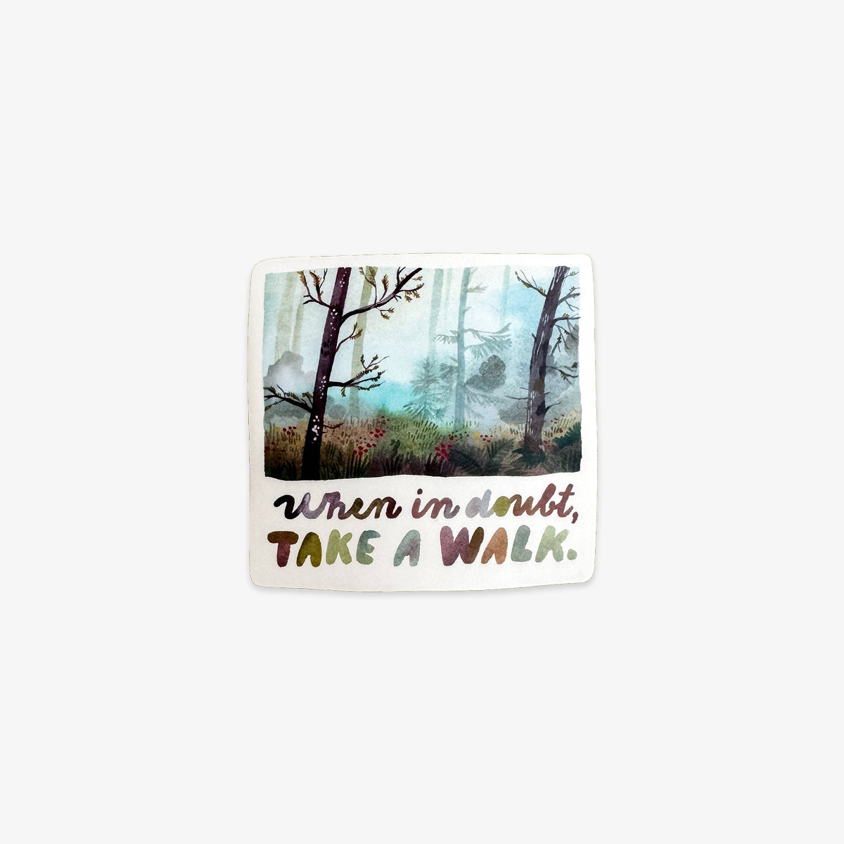 Vinyl sticker with a forest illustration and motivational text on a textured surface
