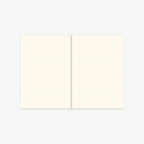 Two cream-colored sheets of paper on a white background. Open notebook with lines.