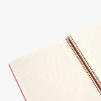 Open notebook with spiral binding on a white background