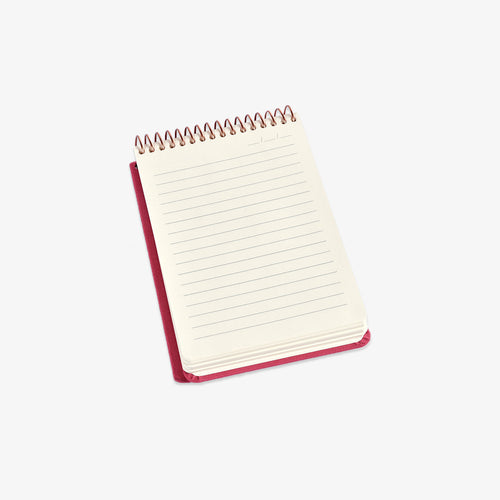 Small spiral-bound notebook with red binding on a white background