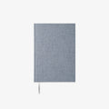 Blue fabric-bound notebook on a white background