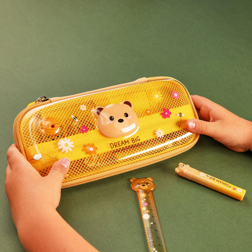 Hardcase pencil case with bear design held by a hand on a green background