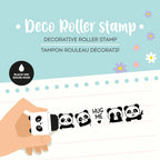 Decorative roller stamp with panda designs on lined paper against a light blue background with flowers.