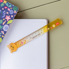 Yellow ruler with bear design on a notebook