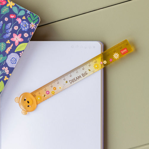 Yellow ruler with bear design on a notebook
