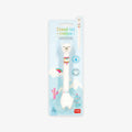 Unicorn-shaped ballpoint pen with base in packaging on a grey background