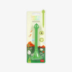 Green stand-up ballpoint pen with base with packaging on a white background