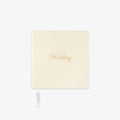 Cream-colored notebook with 'Wedding' in gold text o