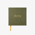 Green notebook with gold text on a white background