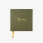 Green notebook with gold text on a white background