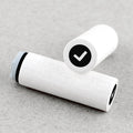 Two white rubber stamps with check symbols on a beige background