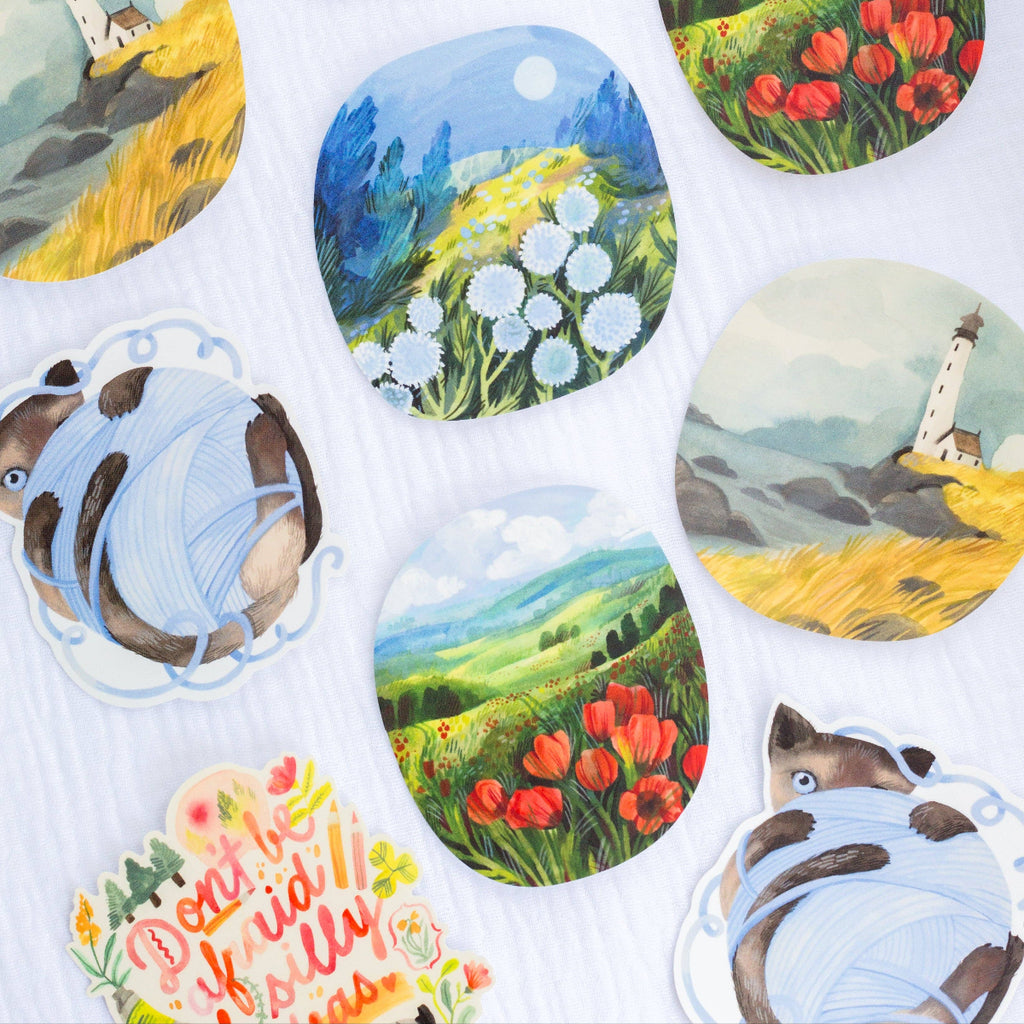 Collection of round stickers with scenic and animal designs on a white background.