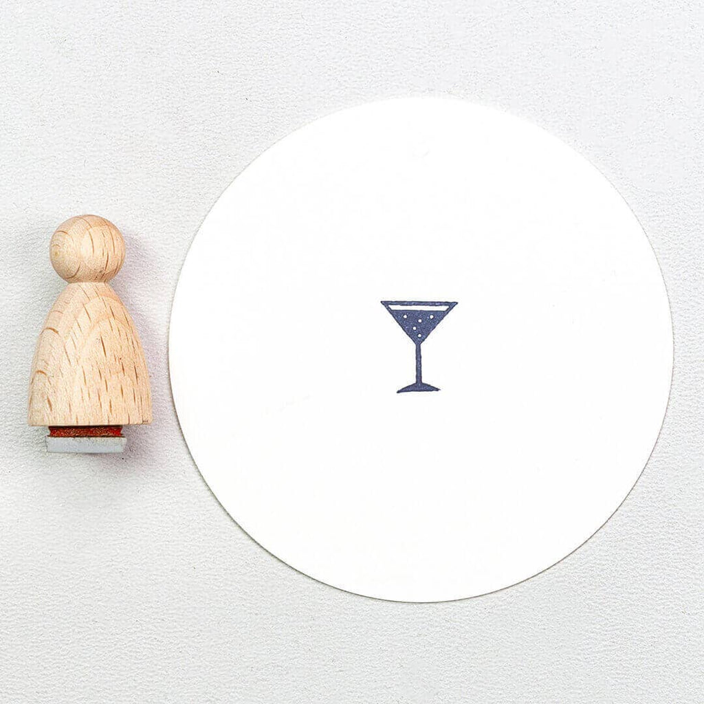 Wooden stamp with a martini glass design on a white background
