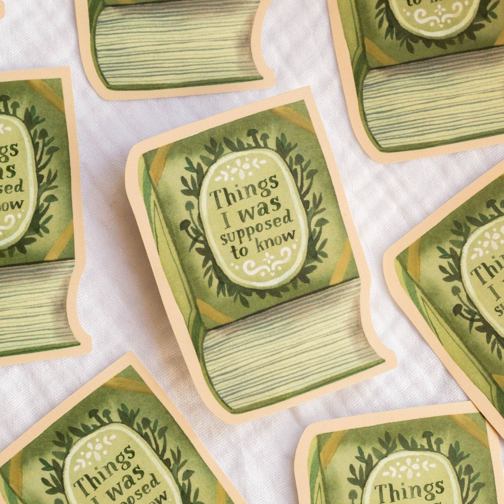 Green book-shaped stickers with 'Things I was supposed to know' text on a white background