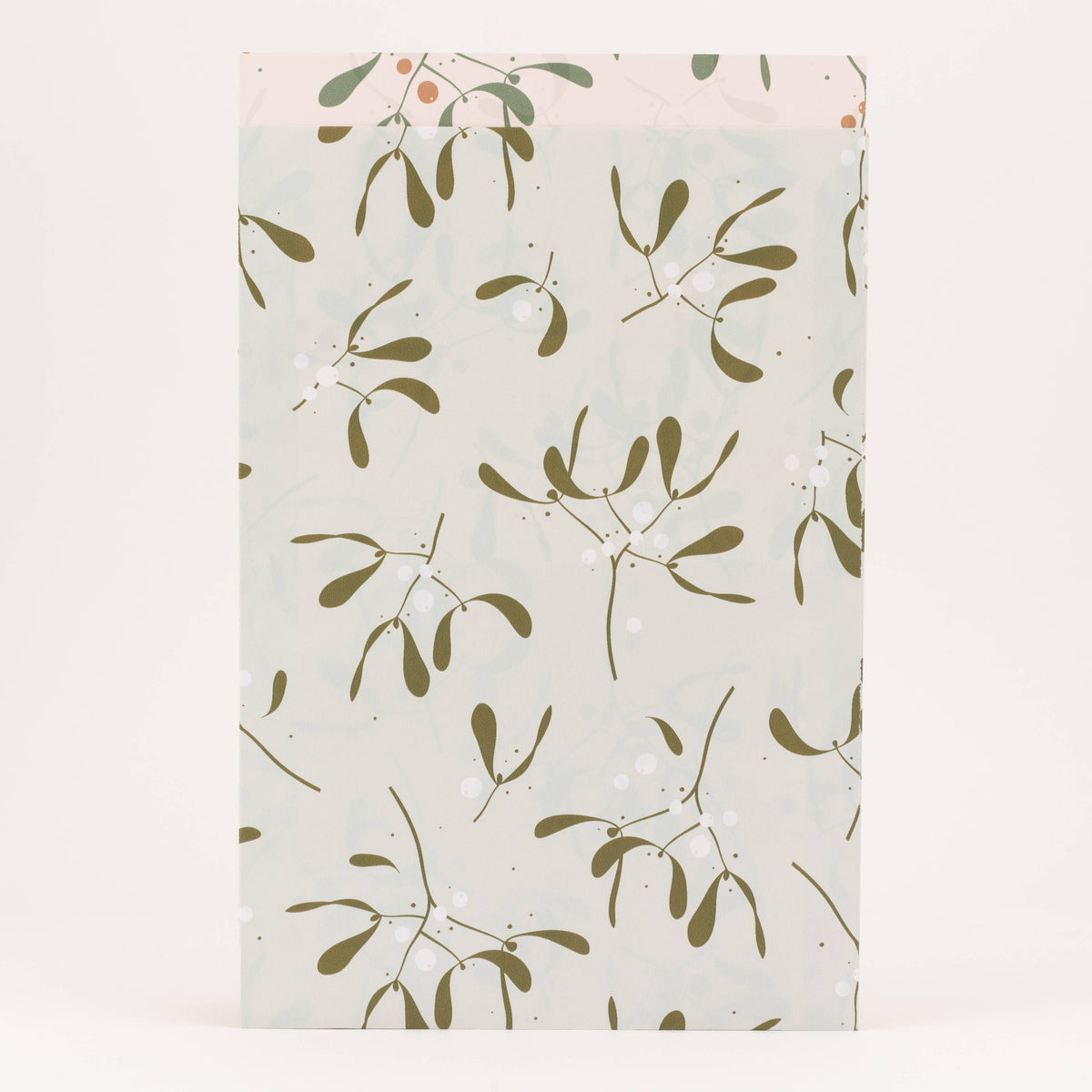 Packaging with a green leaf pattern on a light background