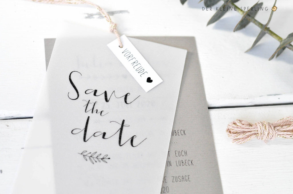 Save the date card with a tag on a white background