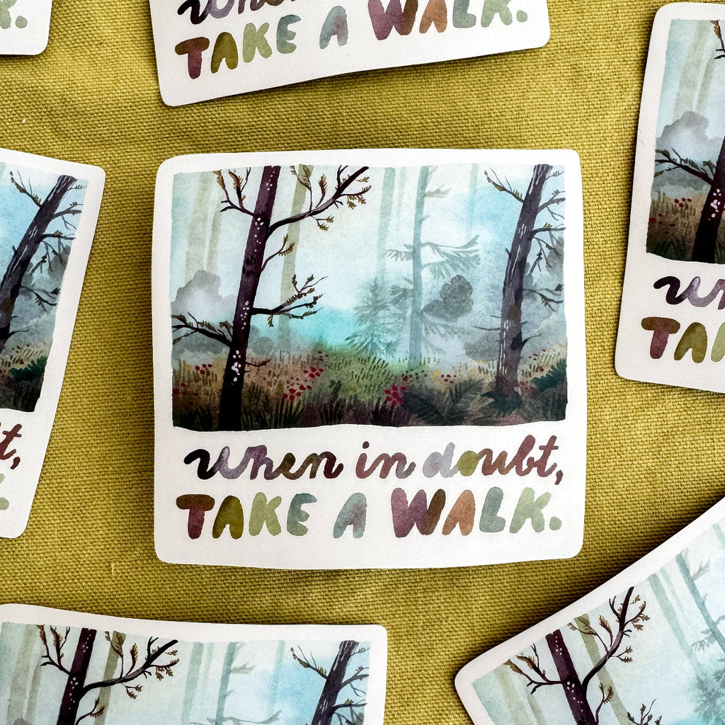 Vinyl sticker with a forest illustration and motivational text on a textured surface