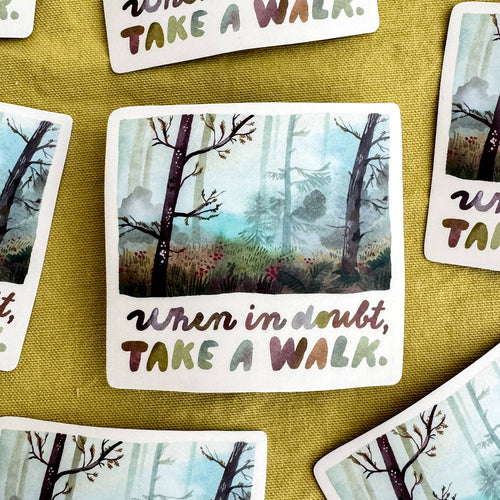 Vinyl sticker with a forest illustration and motivational text on a textured surface