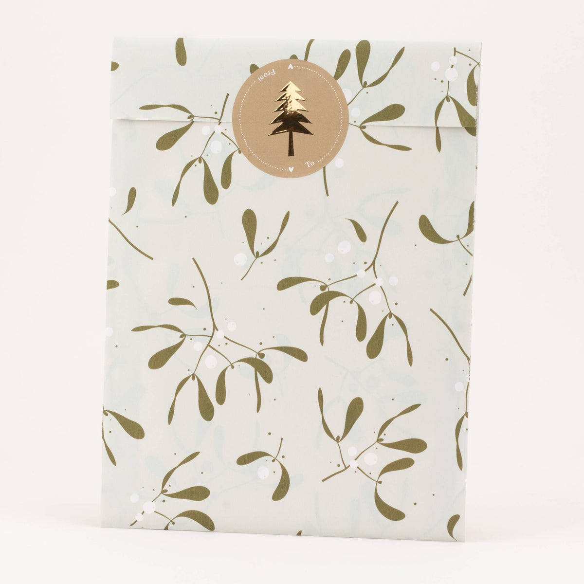 Packaging with a gold mistletoe pattern and a circular logo on a white background