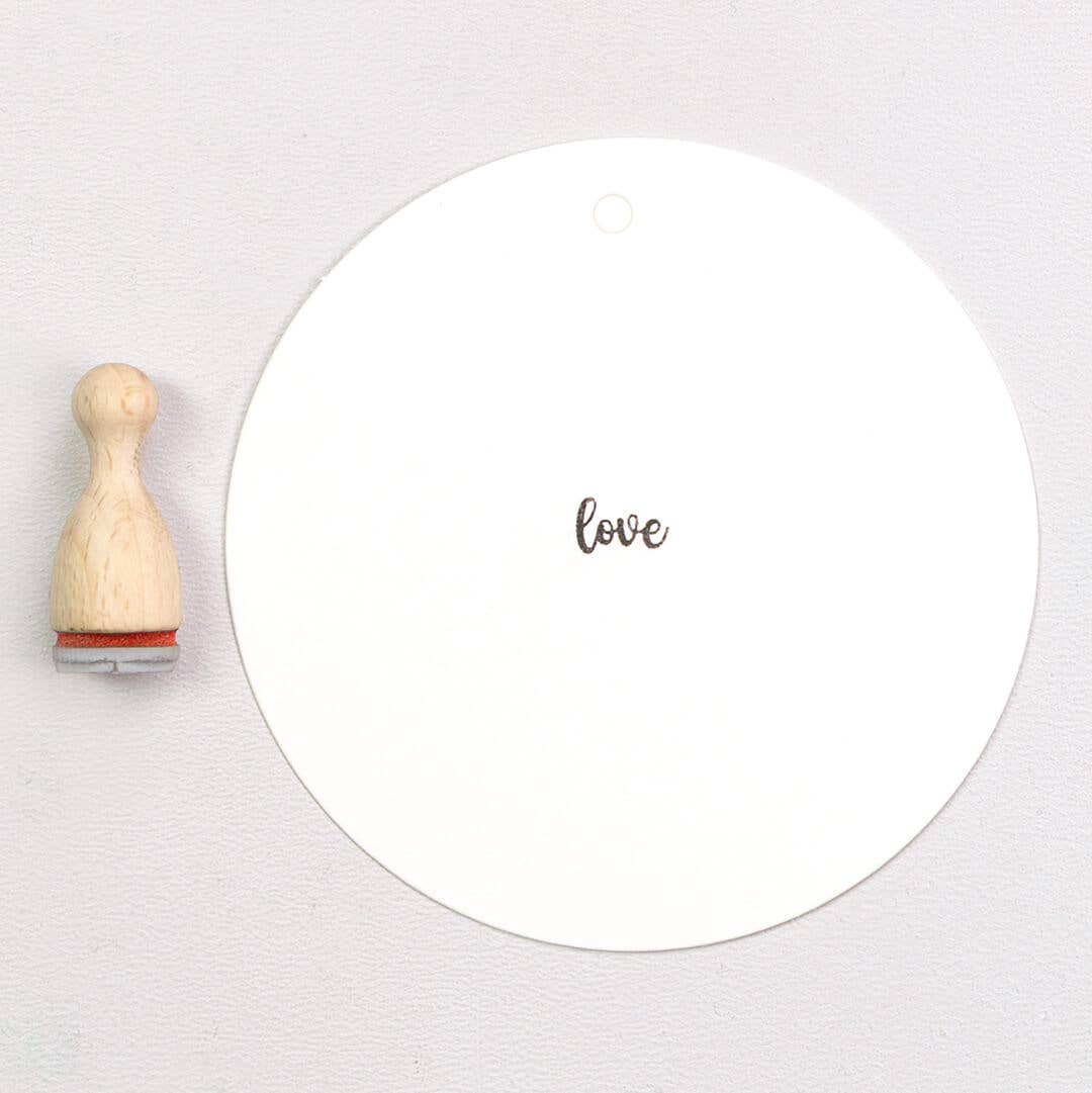 Wooden rubber stamp with the text 'love'